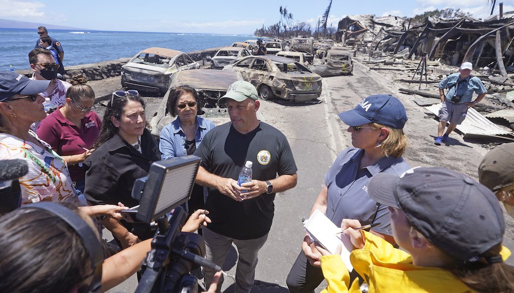 Hawaii Gov. Josh Green, center, speaks to reporters during a tour of wildfire damage Aug. 12, 2023, in Lahaina, Hawaii. (AP)