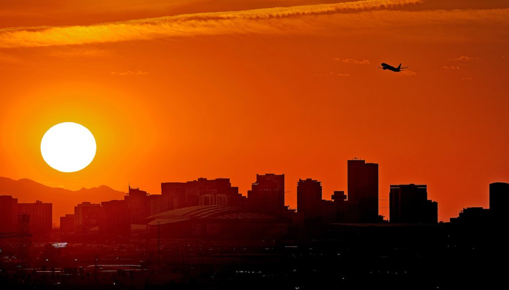 A jet takes flight from Sky Harbor International Airport as the sun sets over Phoenix on July 12, 2023, a day of extreme heat. (AP)